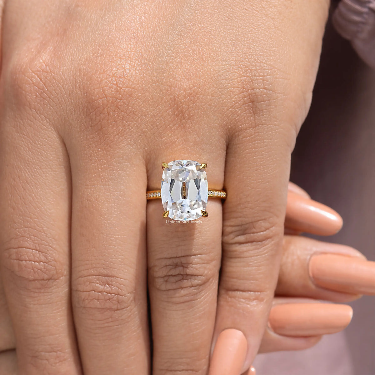 Cushion cut engagement ring with clear center stone and thin pavé band