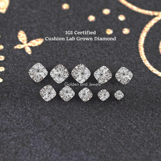 Assorted cushion-cut lab-grown diamonds set on display, mixed sizes and facets