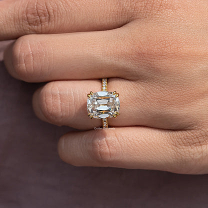 Cushion-cut moissanite ring with accent stones on a slim pavé band