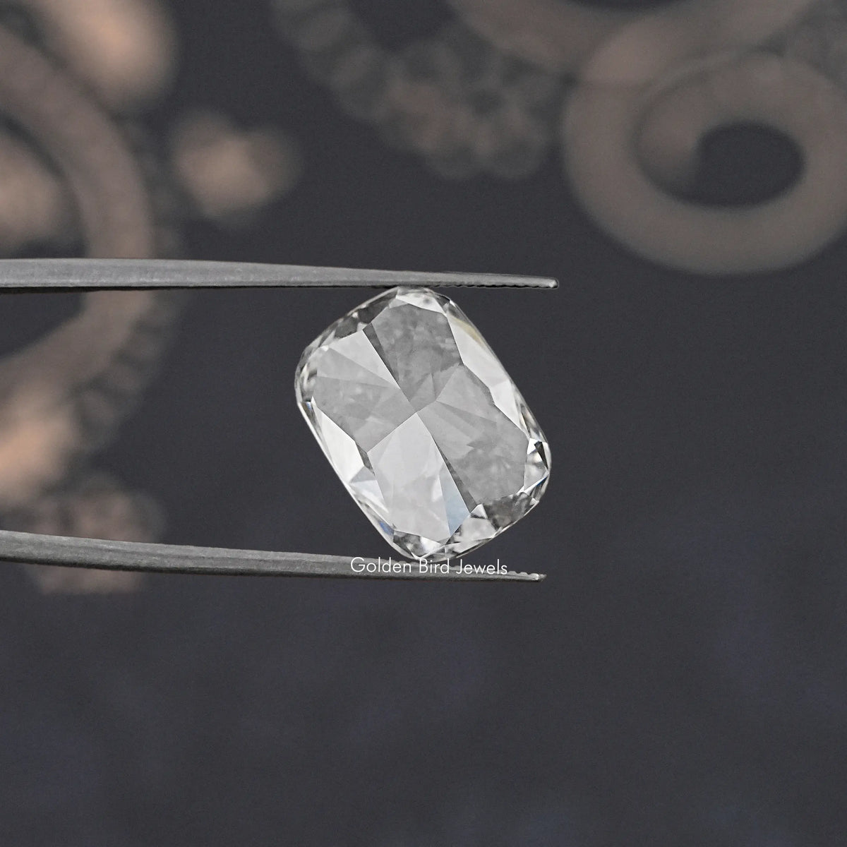 Loose elongated cushion-cut diamond, clear faceted stone in profile view