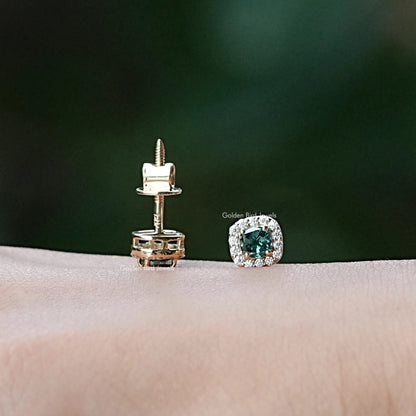 In hand view of moissanite stud earrings in unique shape
