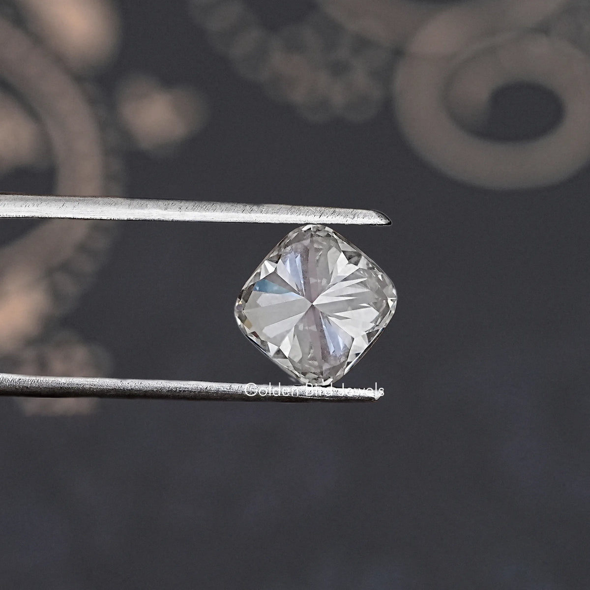 GIA certified cushion-cut lab diamond close-up held by metal tweezers