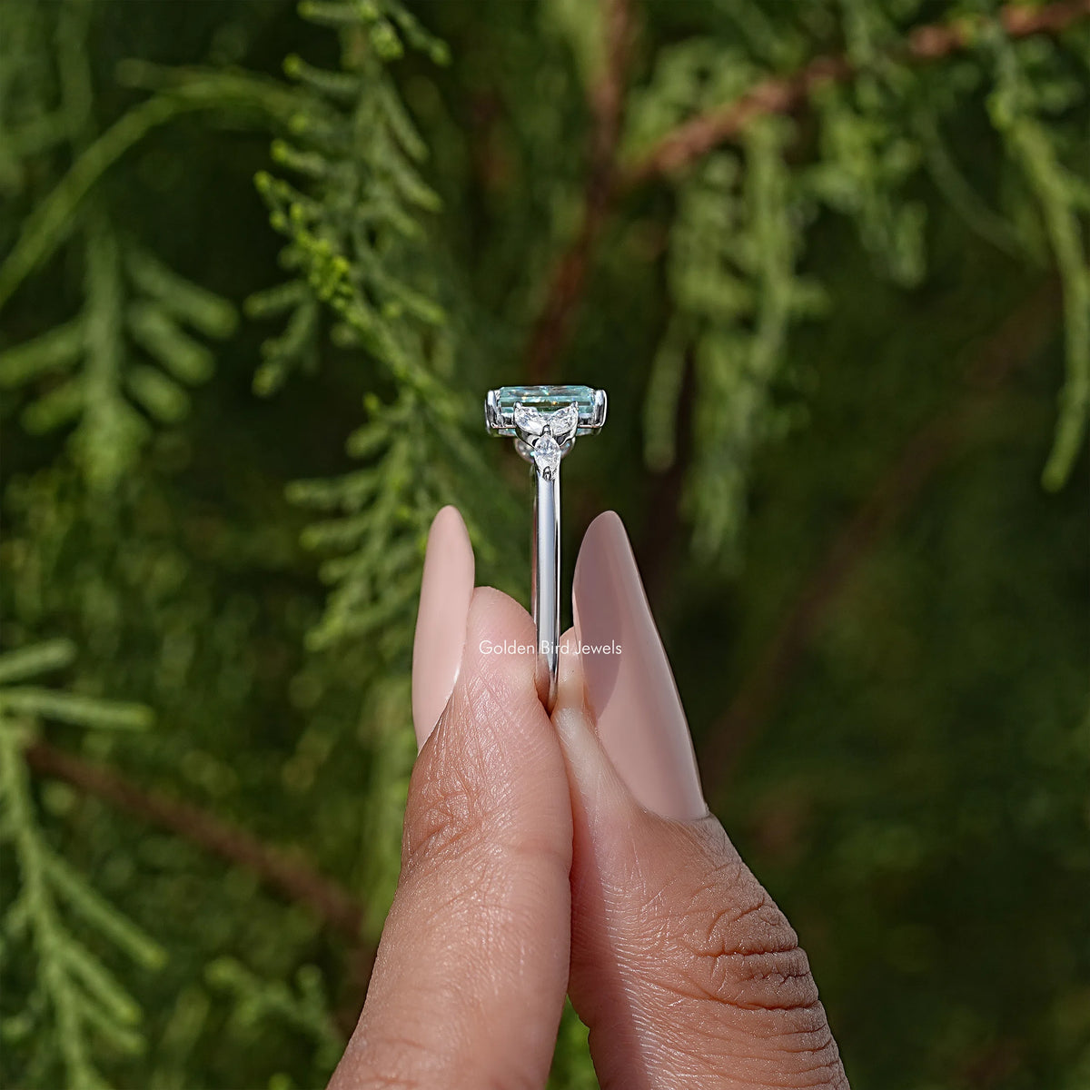 Sterling silver engagement ring with cushion-cut blue-green moissanite prong setting