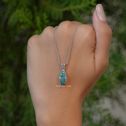 Marquise-cut green solitaire pendant necklace on silver chain, shown on upturned wrist