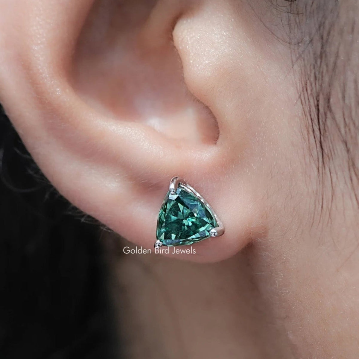 Dark green trillion-cut moissanite stud earrings with triangular stones