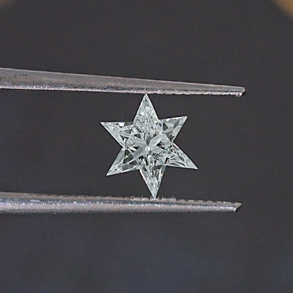 Star-cut loose lab-grown diamond held between metal prongs