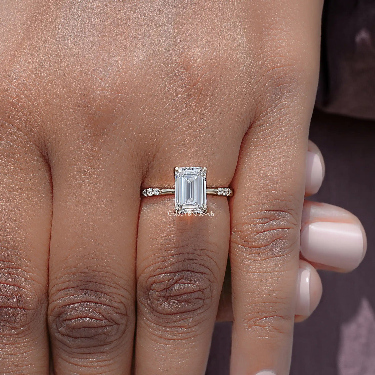 Emerald-cut lab diamond ring with thin band and small pave side accents