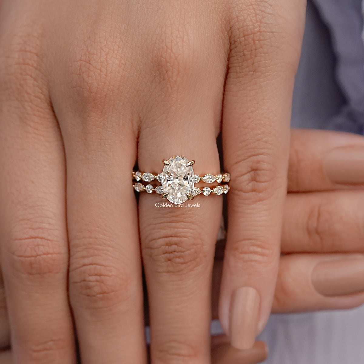 Moissanite bridal ring set with oval center stone and matching pave bands