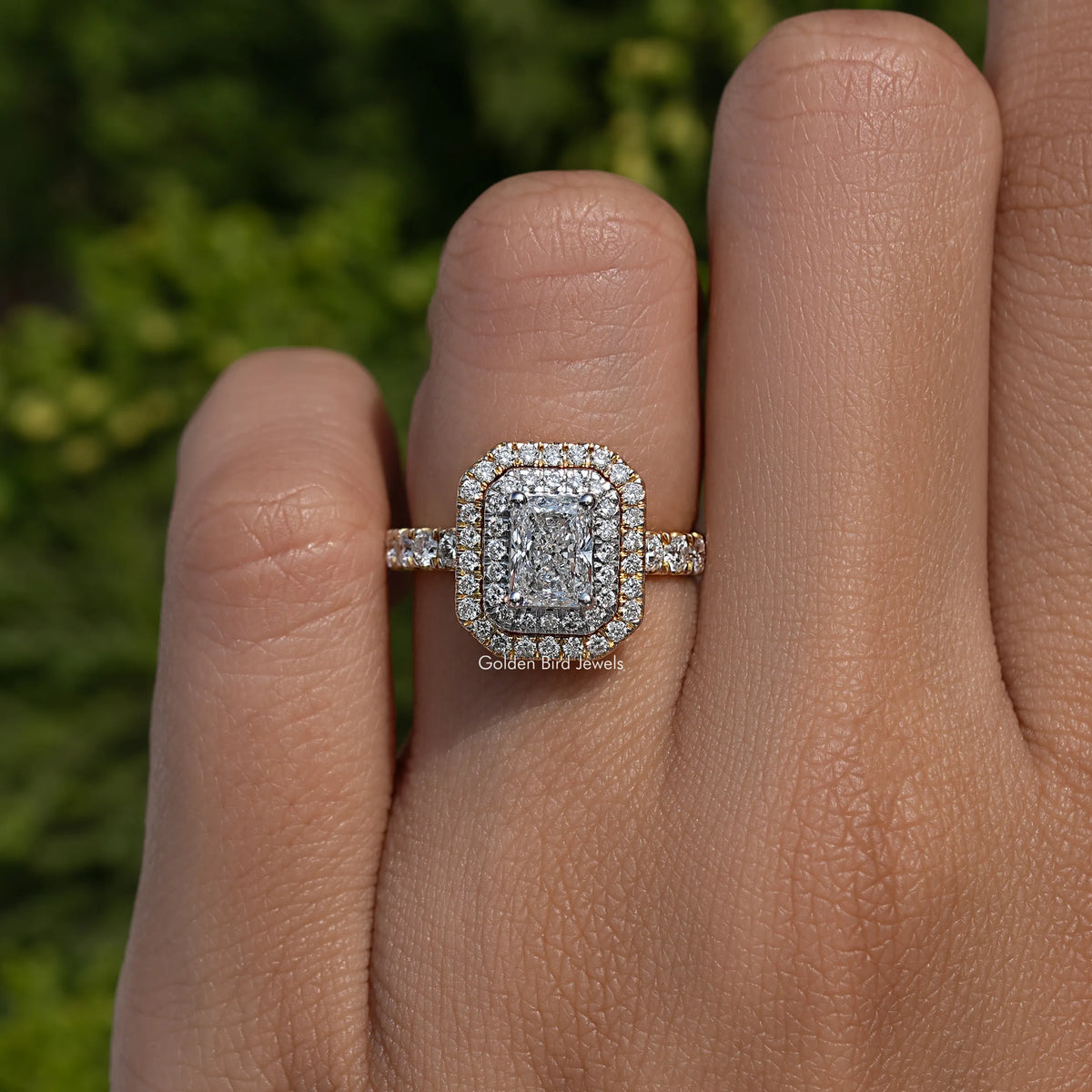 Silver-toned radiant-cut center engagement ring with double halo and slim side band stones