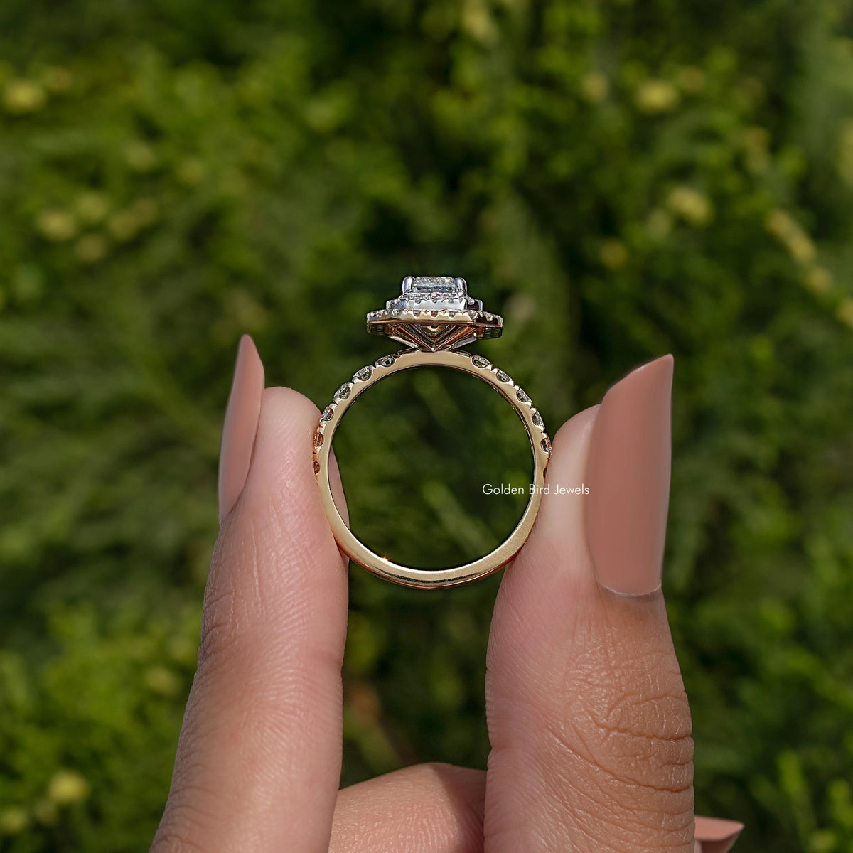 Back view of silver-toned engagement ring showing open gallery and halo crown