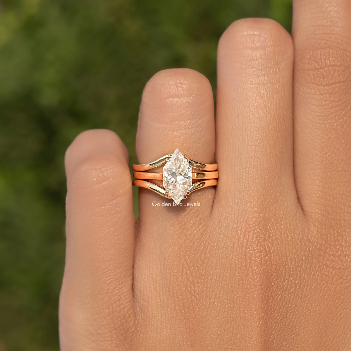Gold tone ring with marquise-style center stone and multi-prong split shank