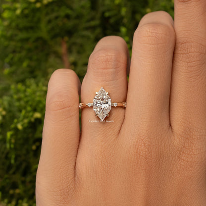 Gold-tone marquise moissanite engagement-style ring with center marquise stone