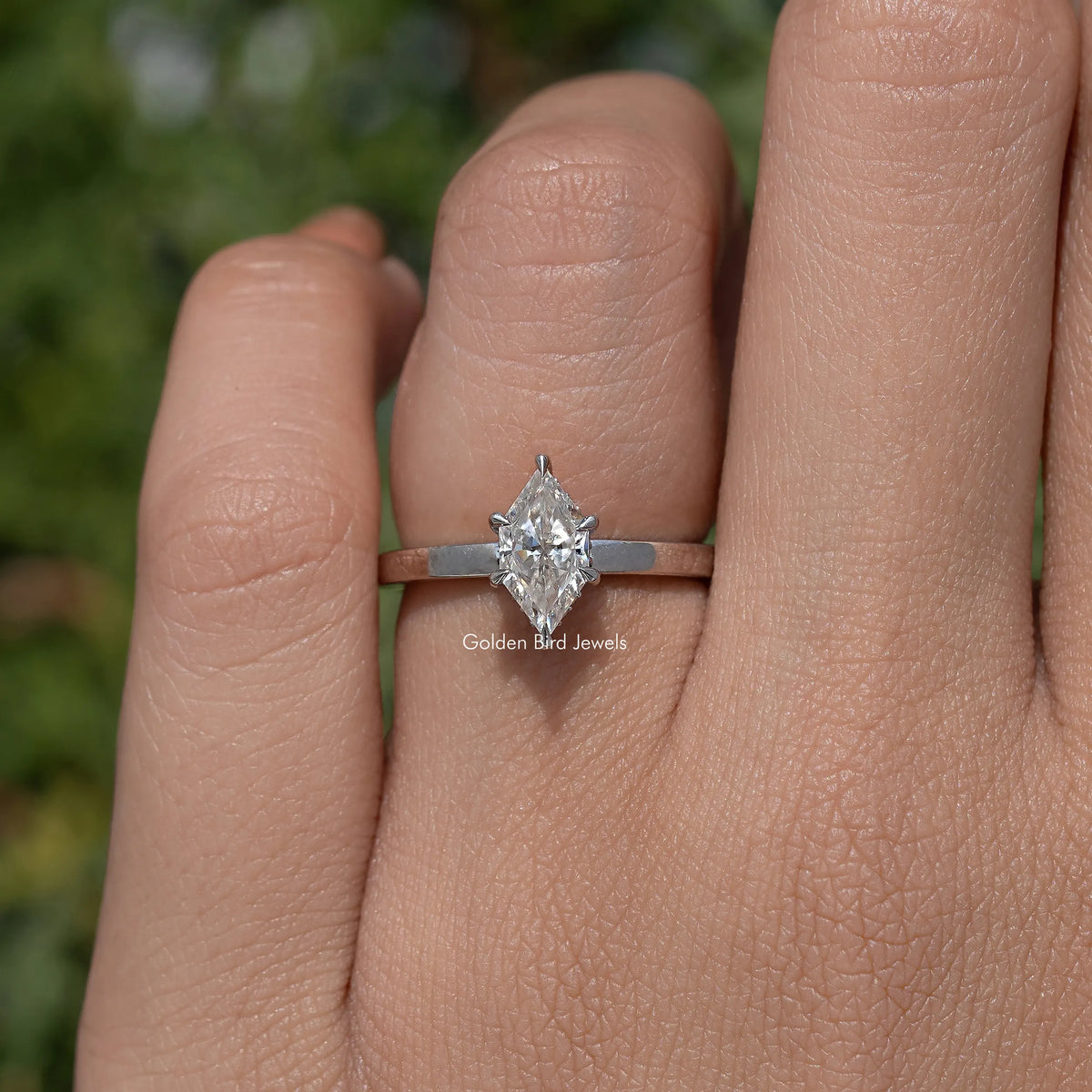 Marquise-cut moissanite engagement ring on finger, silver band, full stone shown