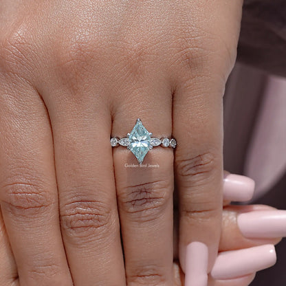 Sterling silver moissanite engagement ring on hand with blue marquise center and small side stones