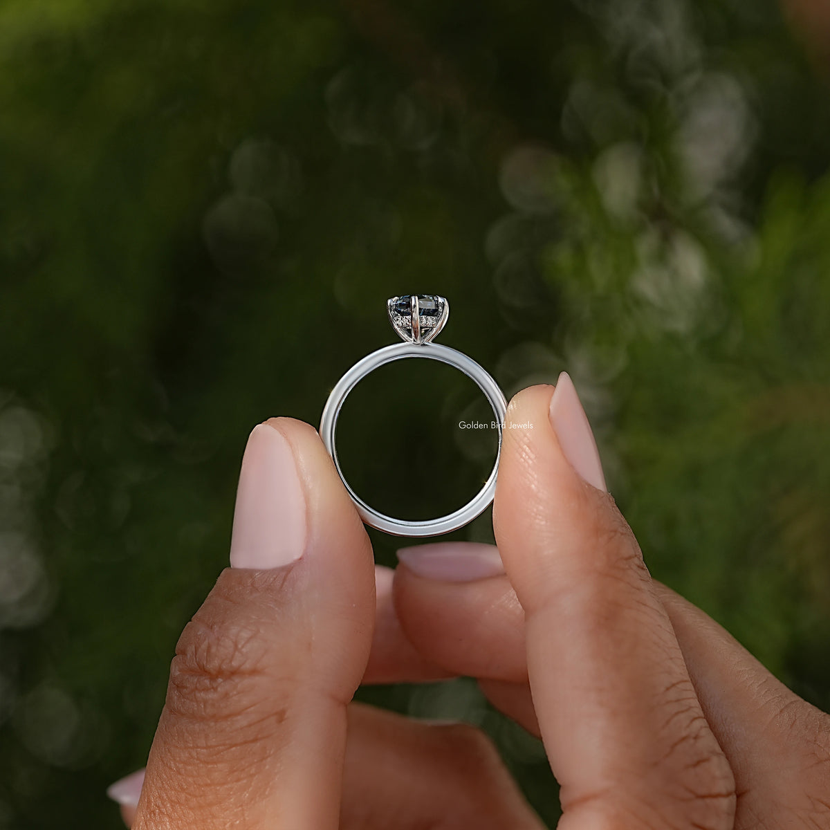 Silver band ring with prong-set blue marquise-cut gemstone