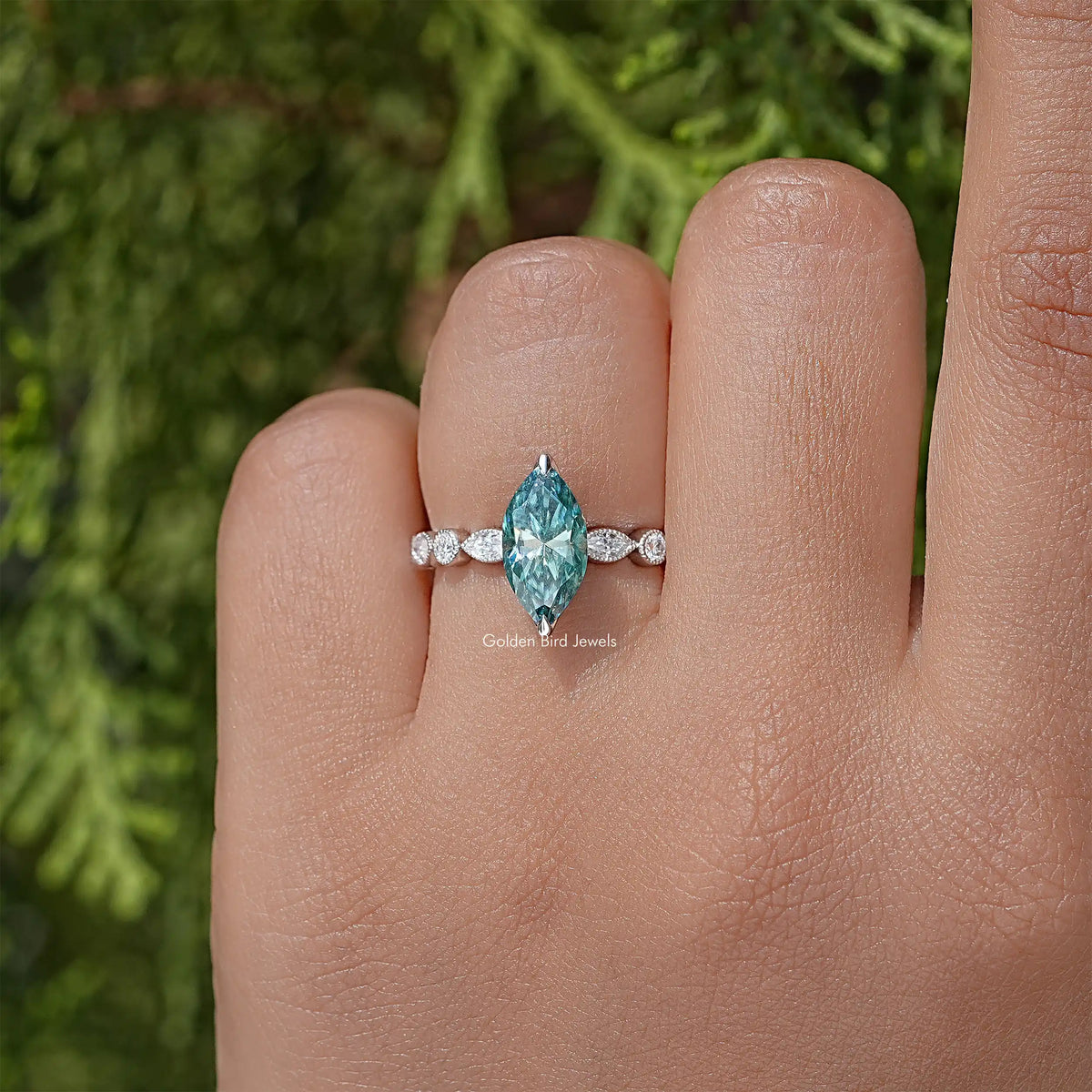 925 sterling silver ring with teal marquise stone and three round accents across band