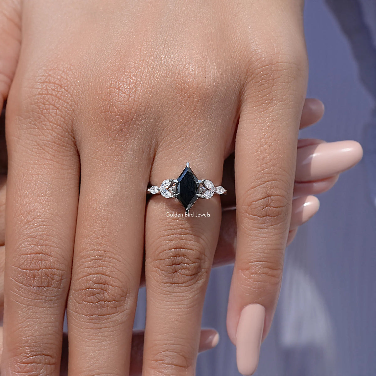 Silver ring with marquise black center stone and leaf-shaped side stones