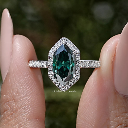 Sterling silver marquise halo accent ring close-up with green oval center and halo