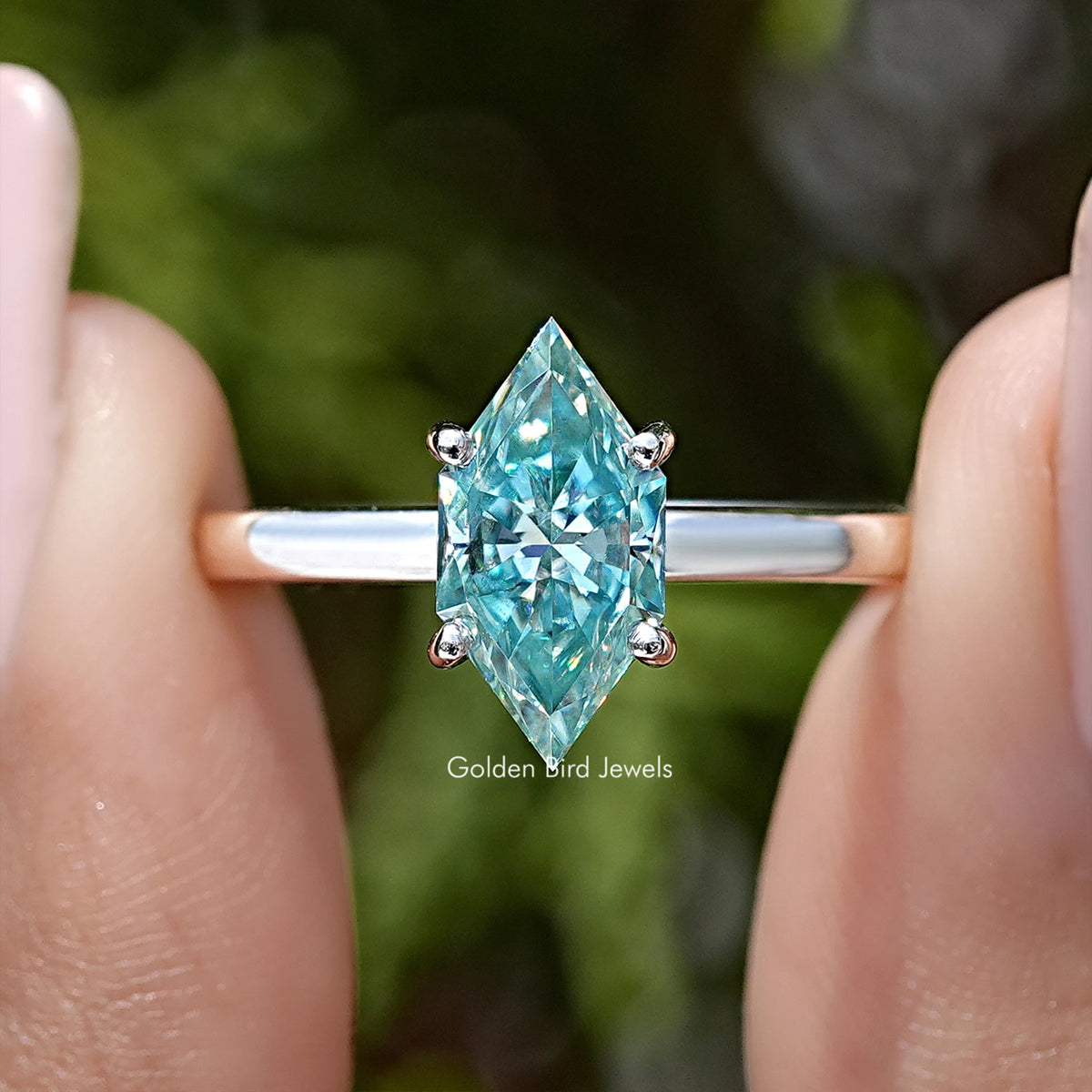 Close-up of 925 sterling silver marquise moissanite solitaire ring, light-blue center