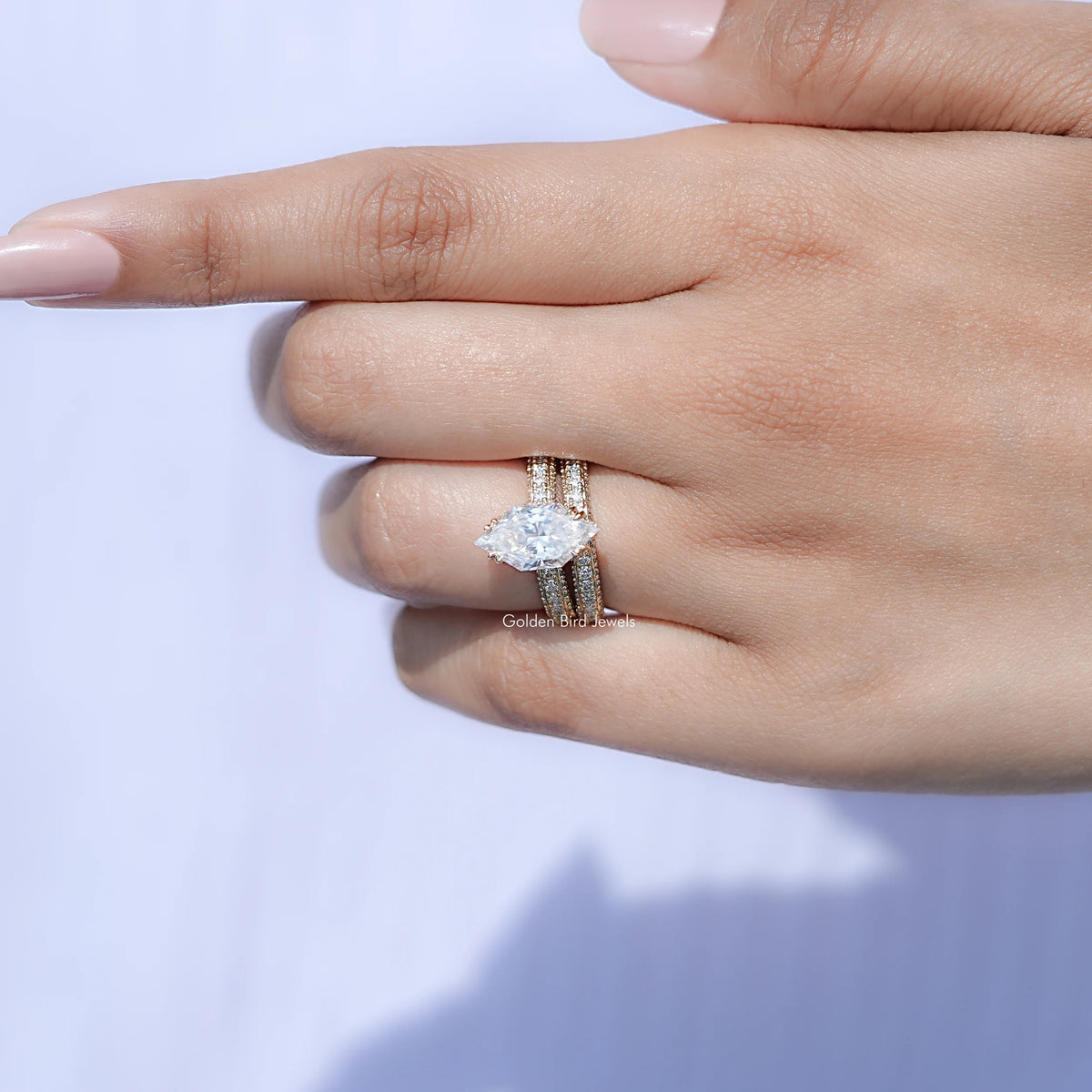 Moissanite bridal ring set with marquise center stone, shown on resting fingers
