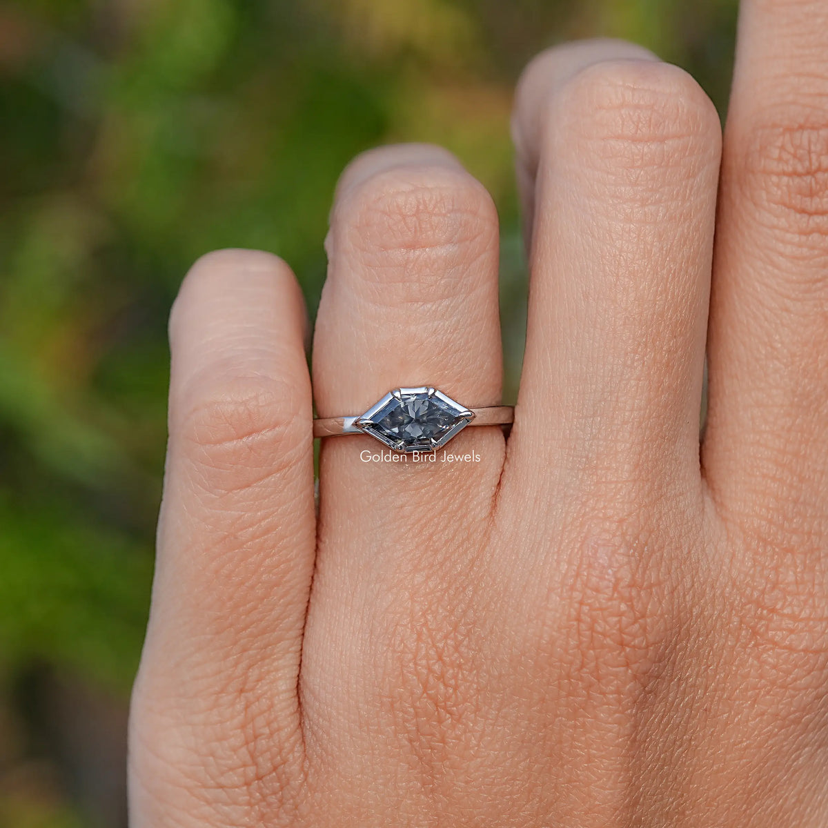 Marquise-cut gray moissanite solitaire ring on hand, side profile