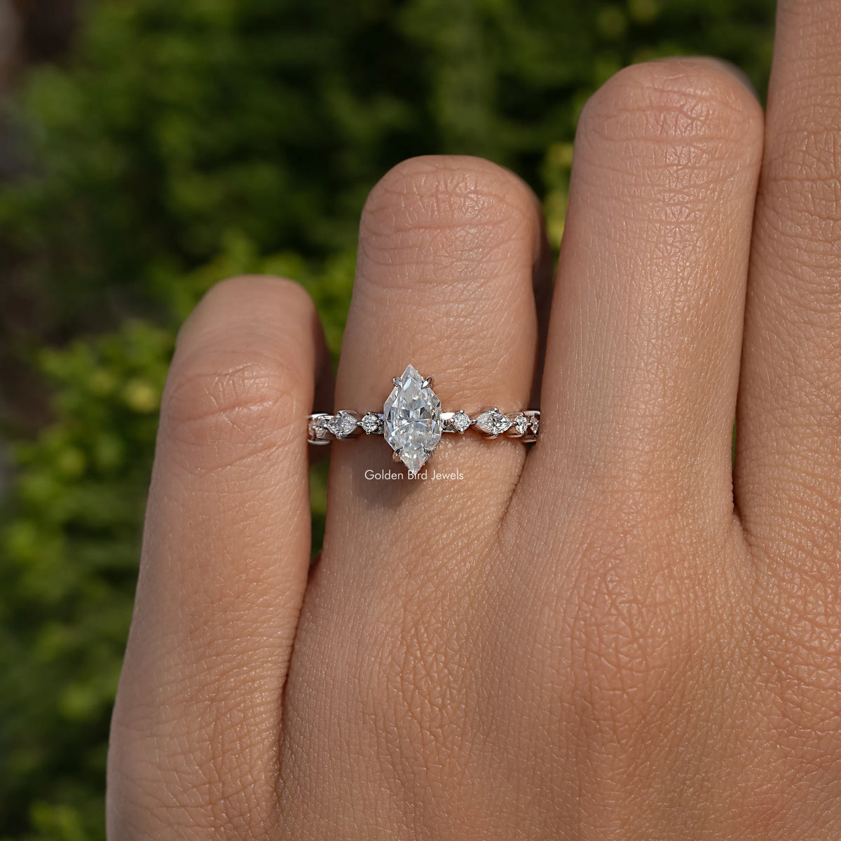 Marquise-cut moissanite engagement ring with central marquise stone and five side stones