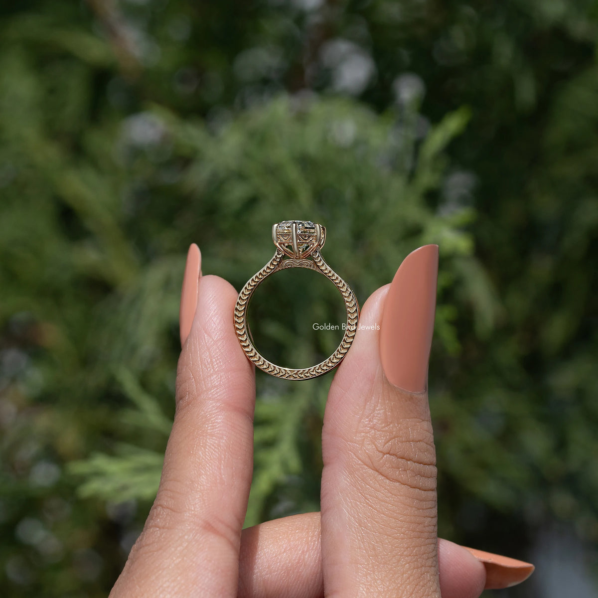 Back view of marquise-style solitaire engagement ring with gold-toned openwork band