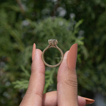 Back view of marquise-style solitaire engagement ring with gold-toned openwork band