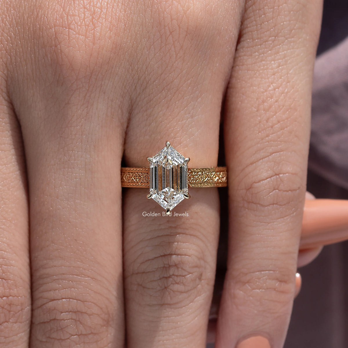 Marquise-style solitaire engagement ring with gold-toned band and prong-set center stone