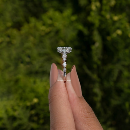 Marquise-cut moissanite engagement ring with raised center stone, fingers holding view