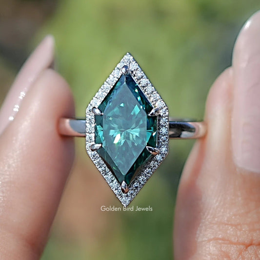 Teal marquise halo engagement ring with rectangular center stone, close-up frontal