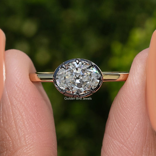 Gold oval-cut moissanite solitaire ring with faceted oval center stone close-up