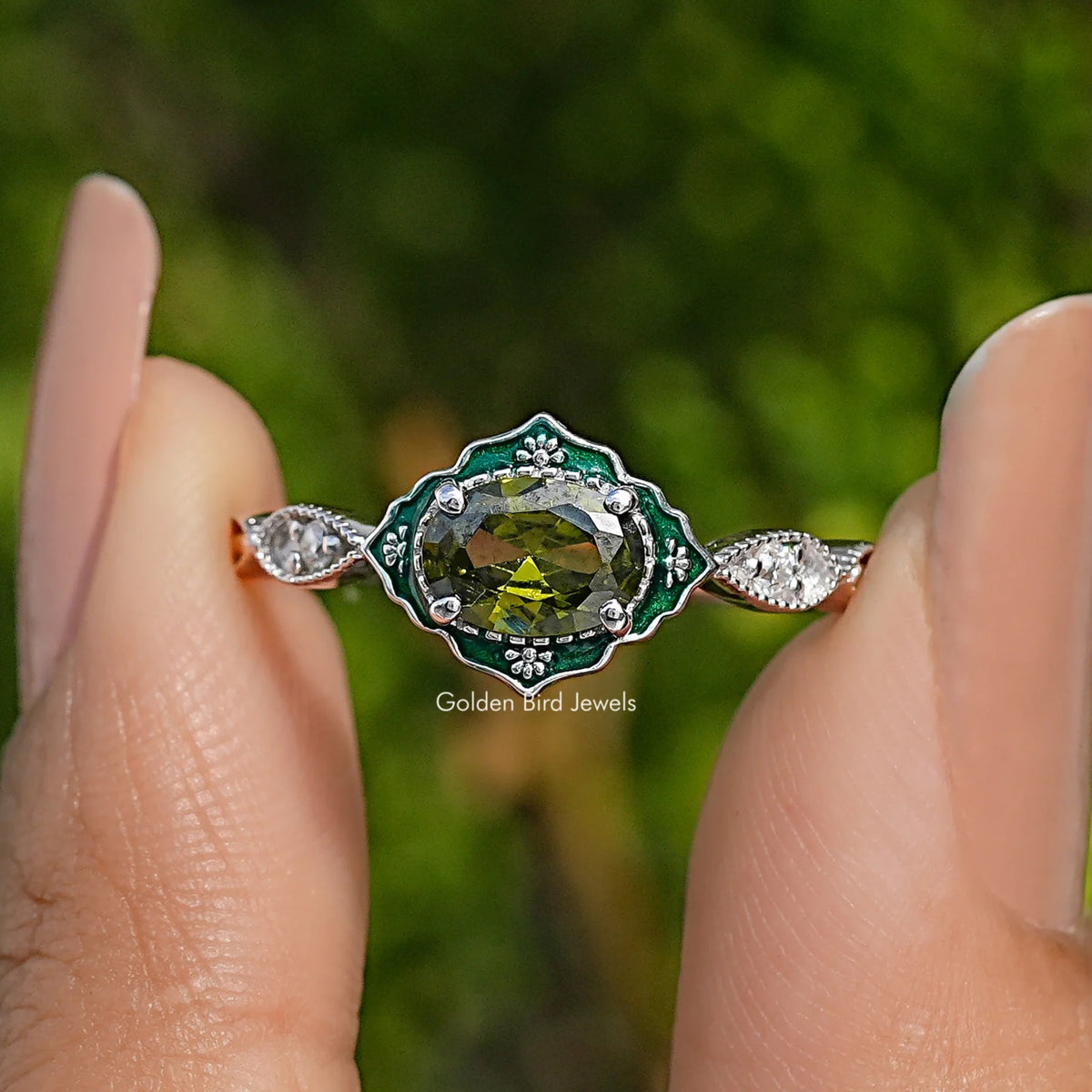 Oval green gemstone engagement ring with diamond halo and prong-set side stones