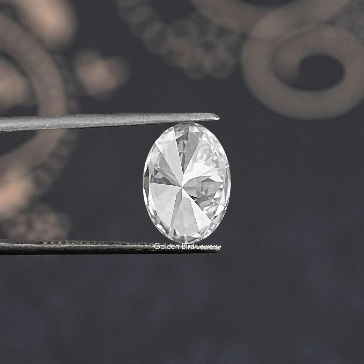 Oval-cut lab-grown diamond held between metal prongs, full face view