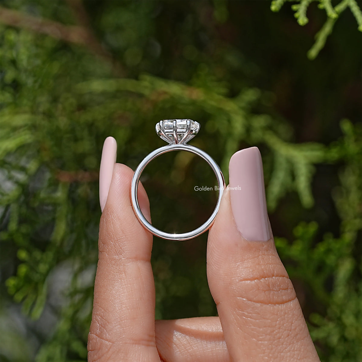 Silver ring profile with cushion-cut moissanite center on fingers