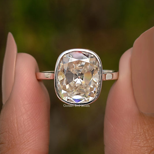 Sterling silver elongated cushion moissanite ring close-up with reflective bezel frame