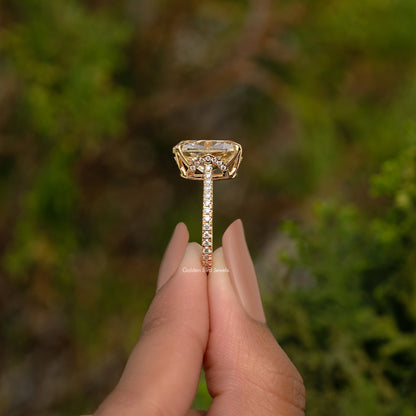 Gold-tone engagement ring with elongated cushion center and hidden halo, prong-set