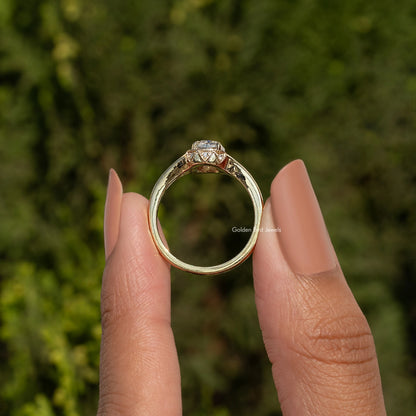 Elongated cushion-cut moissanite ring, back view of gold-toned band and prongs