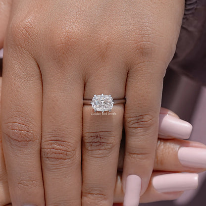 Silver cushion-cut moissanite ring on hand with slim band