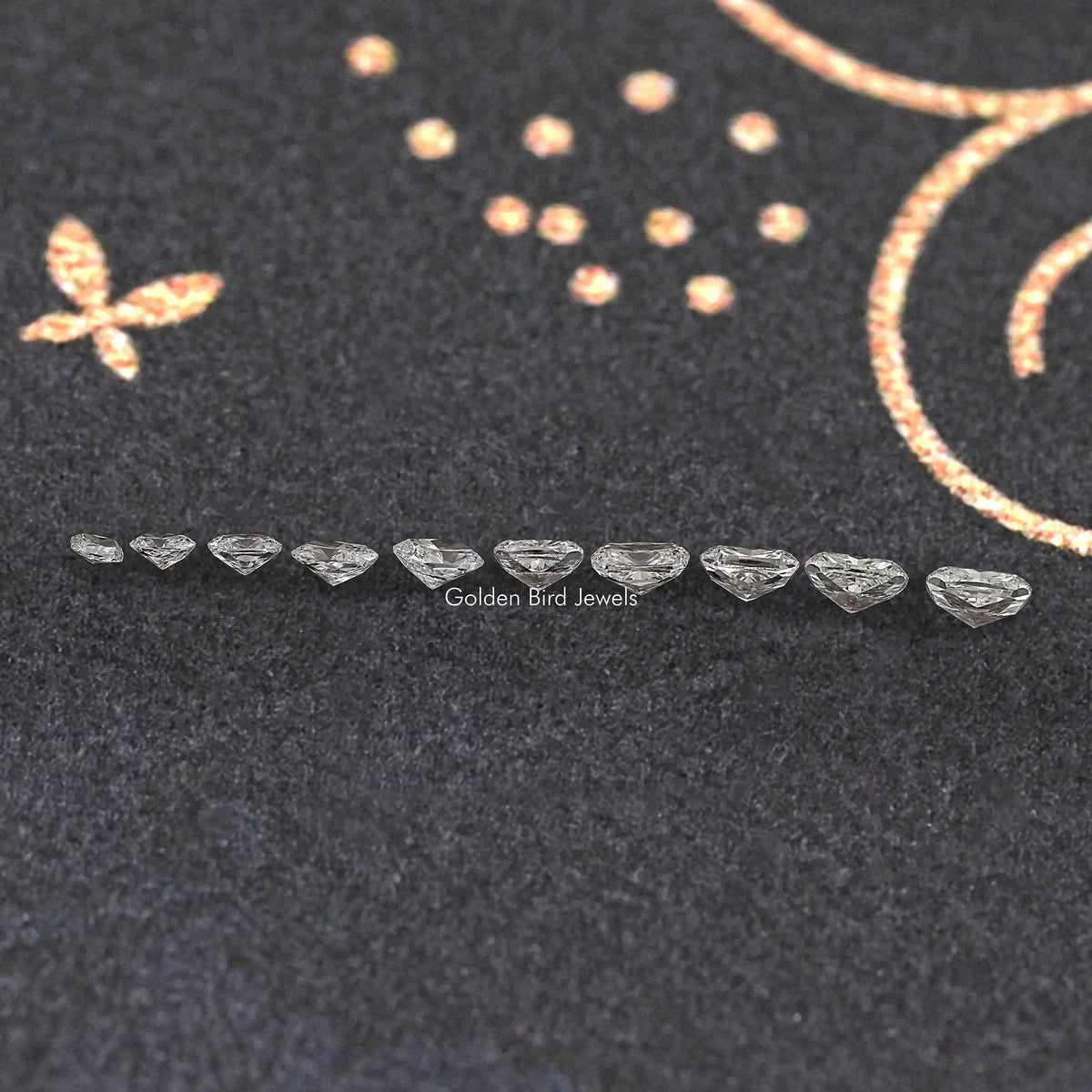 Row of small cushion-cut diamonds laid on a fabric surface