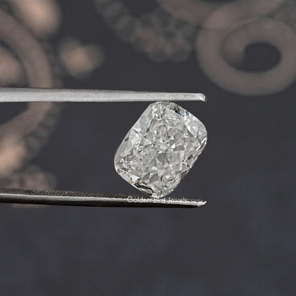 Loose lab-grown diamond, elongated cushion cut, icy white, held between metal tweezers.