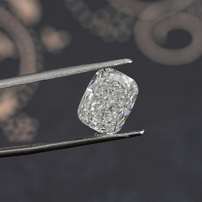 Loose lab-grown diamond, elongated cushion cut, bright white facets, held in tweezers.