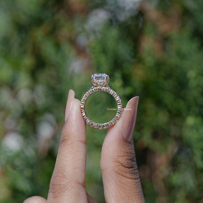 Moissanite ring set with elongated cushion-cut center stone in a halo setting