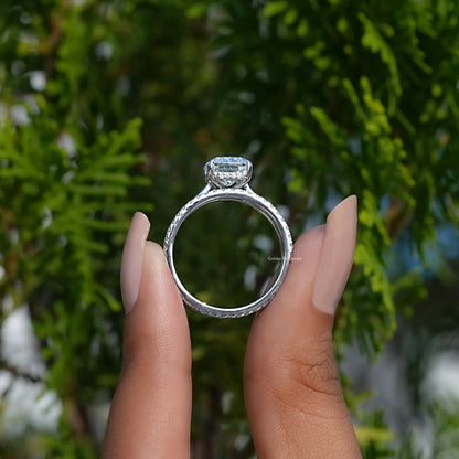 Silver-tone ring with elongated cushion moissanite center and square halo top