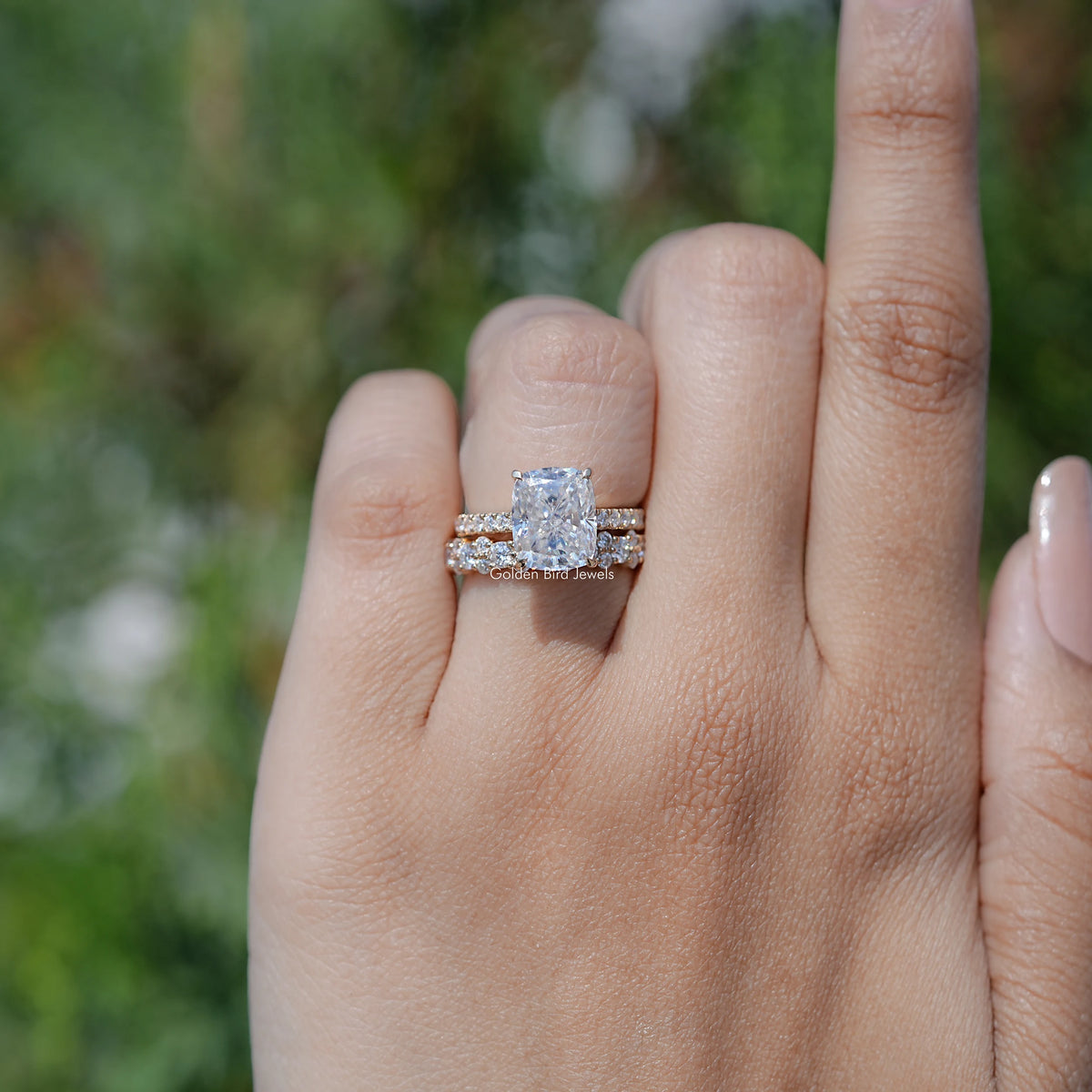 Moissanite ring set with elongated cushion cut center stone