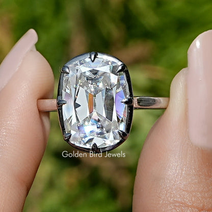 Front view of Moissanite Elongated Old Mine Cushion Cut Ring in two fingers 