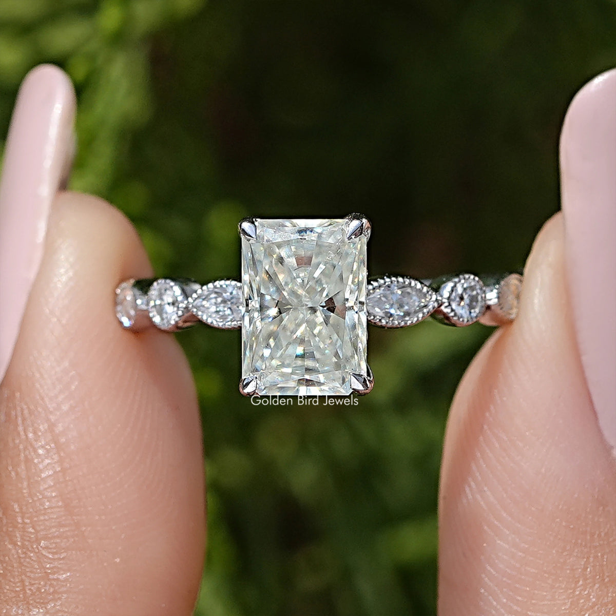 Radiant cut moissanite engagement ring close-up, square center with two round side stones