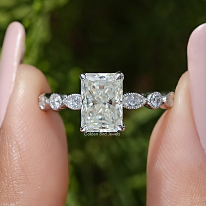 Radiant cut moissanite engagement ring close-up, square center with two round side stones