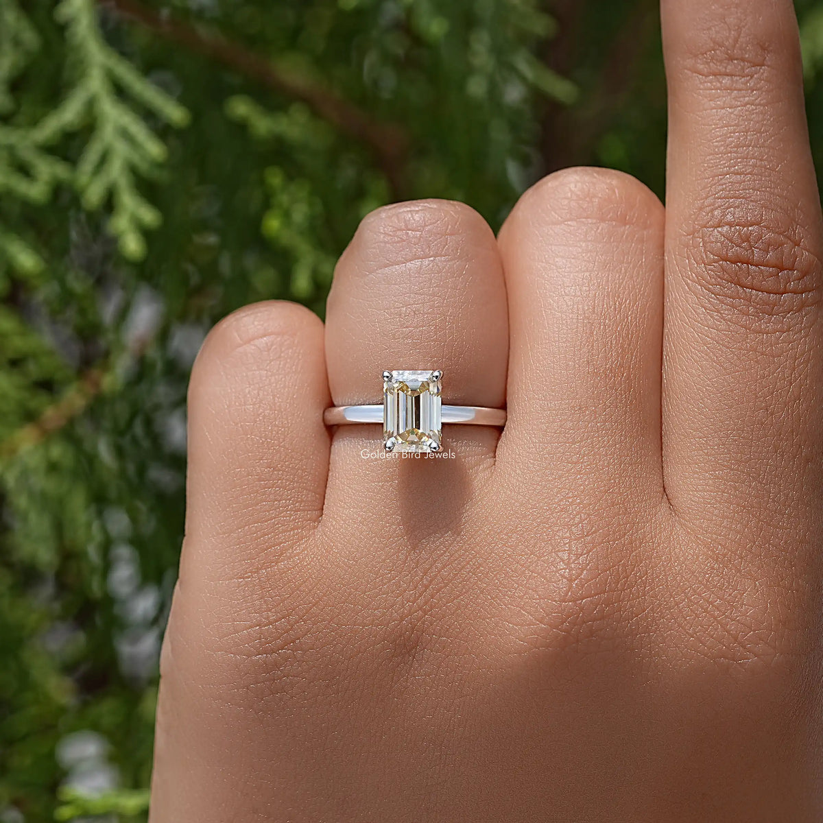 Yellow emerald-cut moissanite solitaire ring on sterling silver band, front view