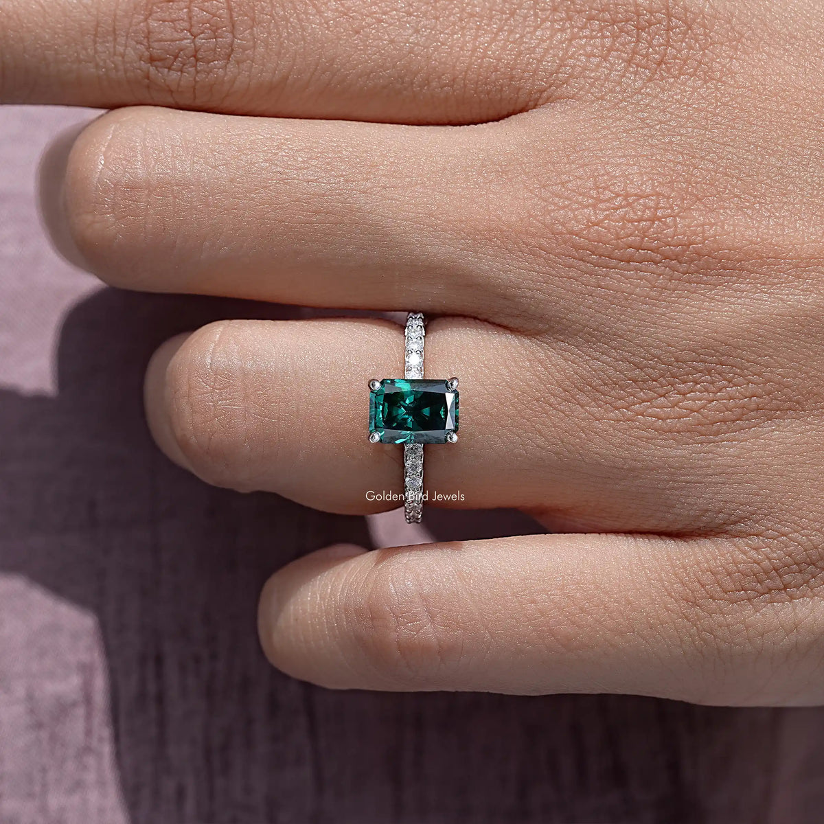 Sterling silver ring featuring a square emerald-cut green moissanite solitaire